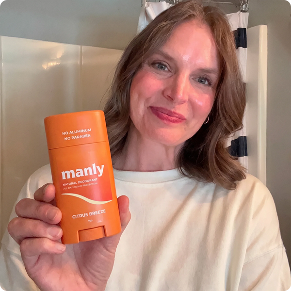 Mom holding the Manly Citrus Breeze natural deodorant