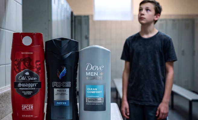 Drugstore men's grooming bottles in a locker room